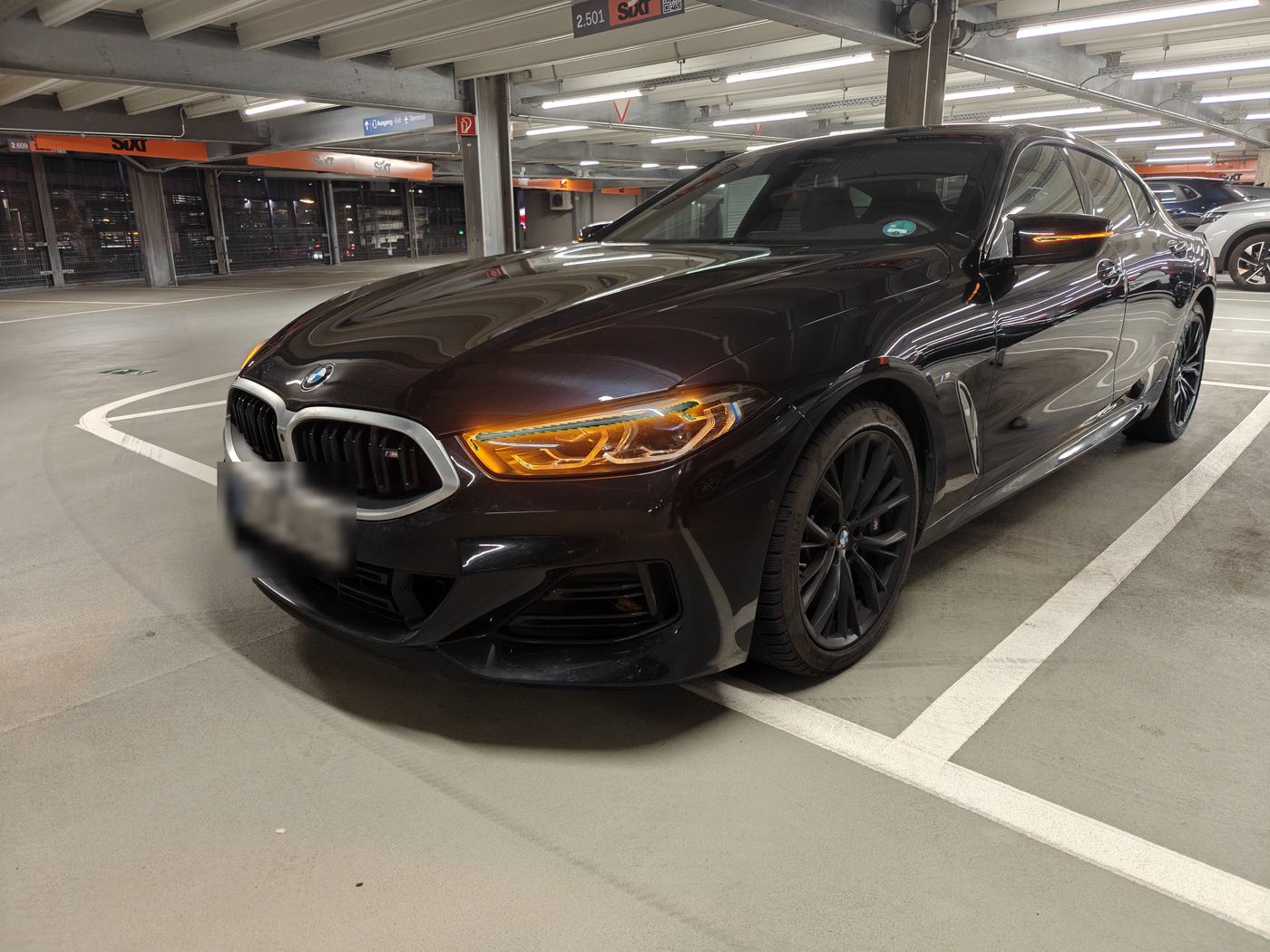 Dunkler BMW in einem Parkhaus, Frontansicht